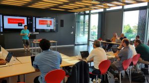 Imad Aad presenting eID privacy in front of an audience.